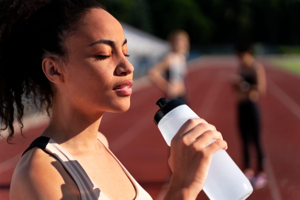 fit woman drinking water