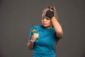 fit woman taking alcohol after the gym