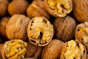 Fresh whole and cracked walnuts showcasing their textured shells and nutritious insides.
