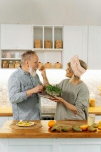 Senior couple preparing a healthy breakfast together in their modern home kitchen.