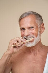 elderly man brushing teeth