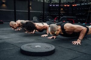 Group workout session in a Mexico City gym with athletes doing push-ups.