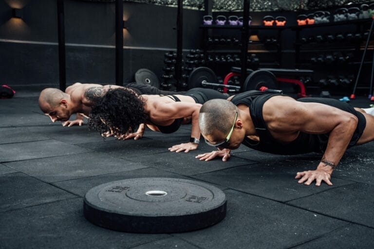 Group workout session in a Mexico City gym with athletes doing push-ups.