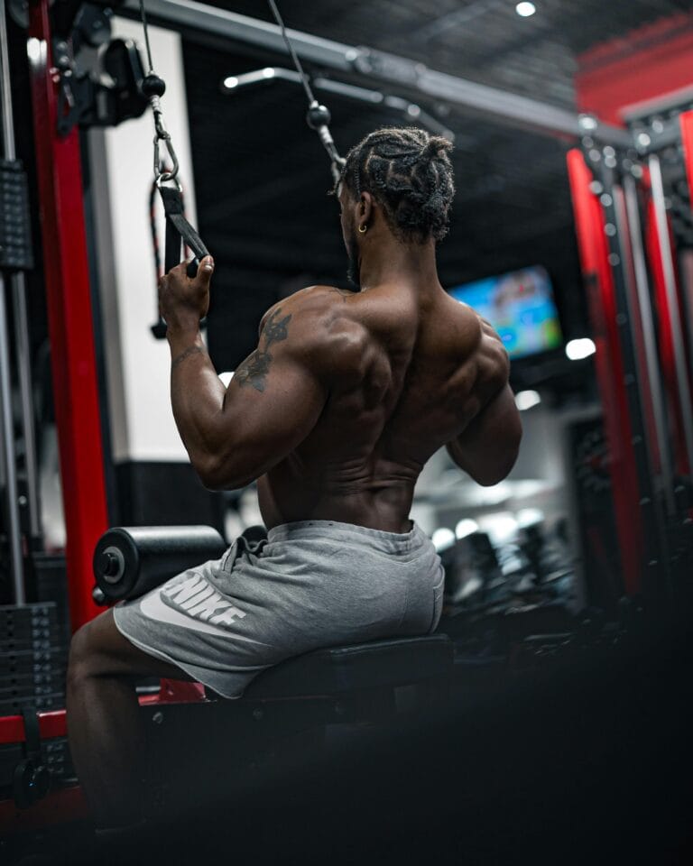 Dedicated athlete performing weightlifting exercises in a modern gym, showcasing strength and focus.