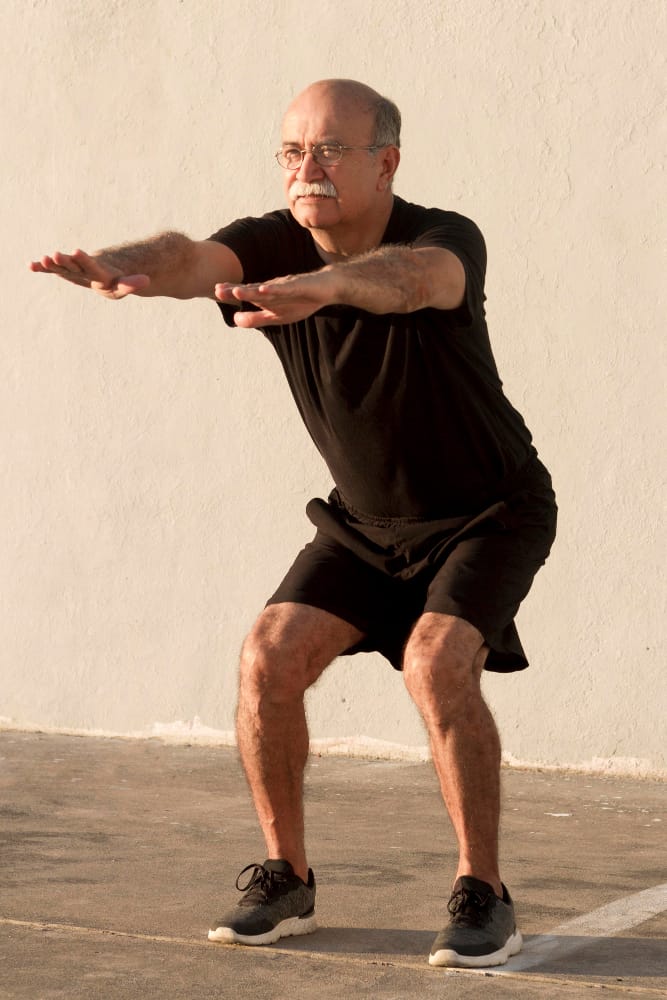 elderly man squating