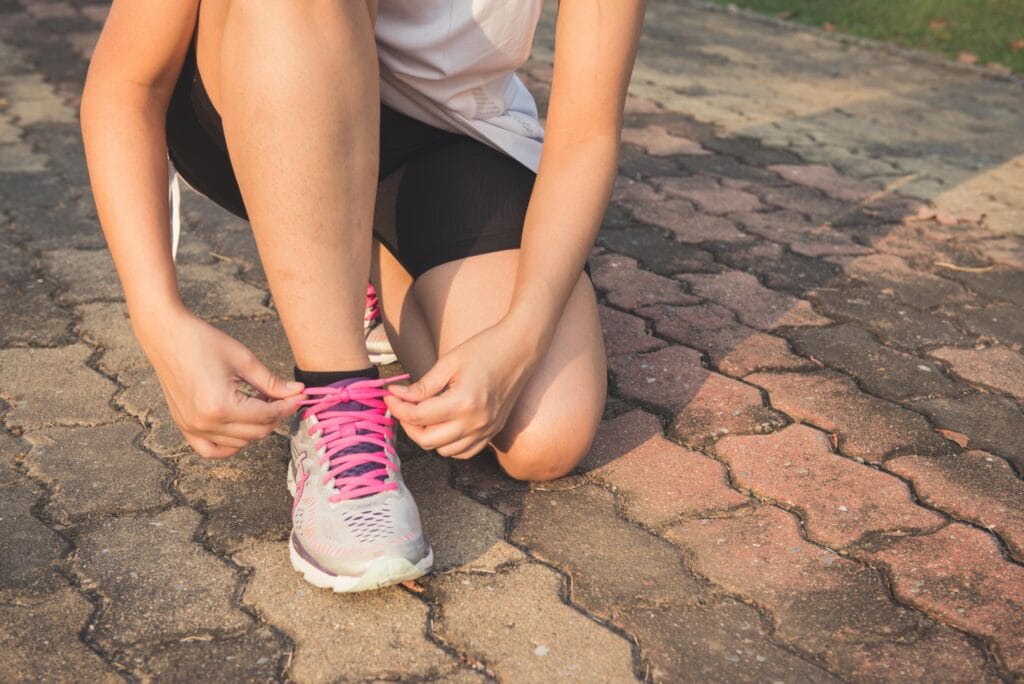 woman tying her shoe lace