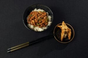 Top view of natto on rice with fried dumplings, perfect for an authentic Japanese meal setting.