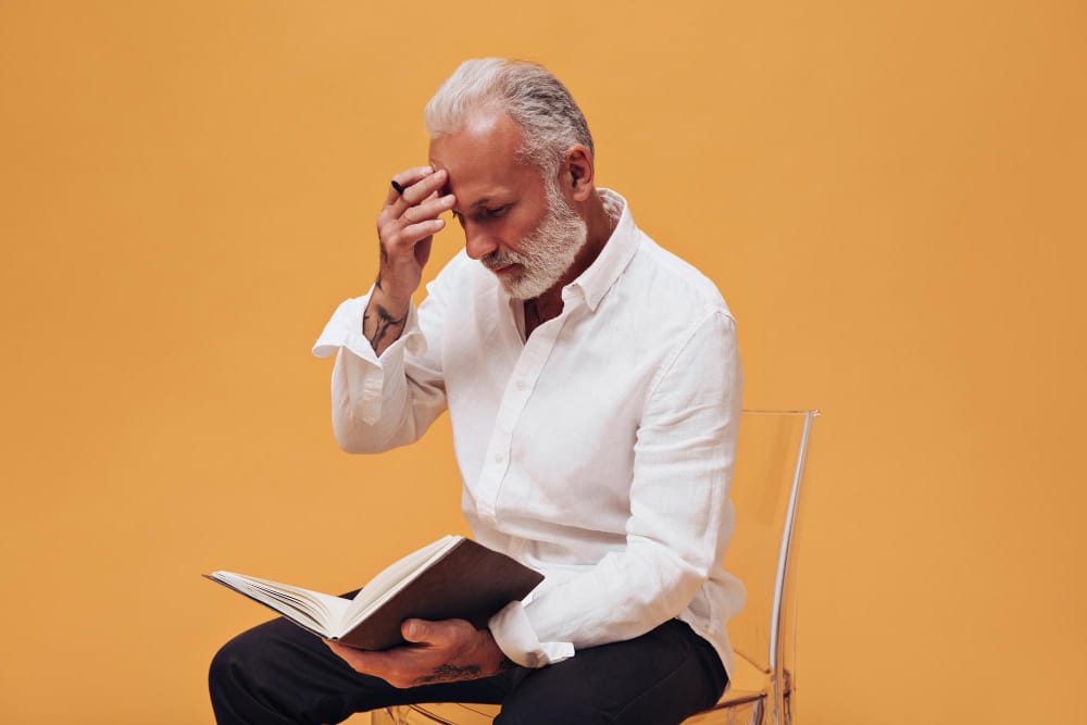 handsome elderly man reading a book