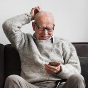 forgetful elderly man using phone