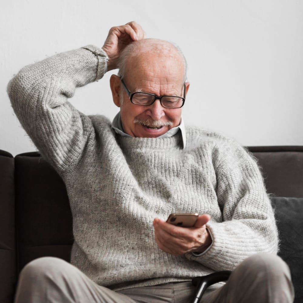 forgetful elderly man using phone