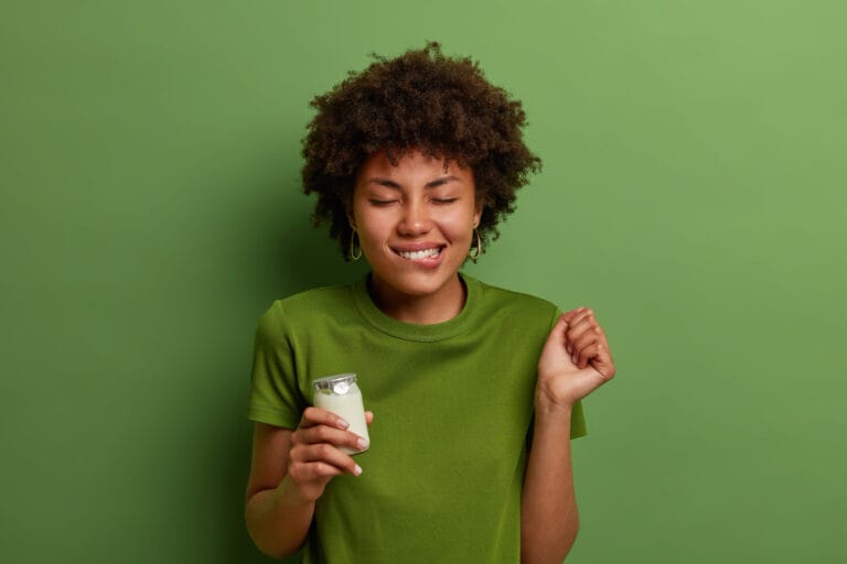 young woman holding a drink. kefir
