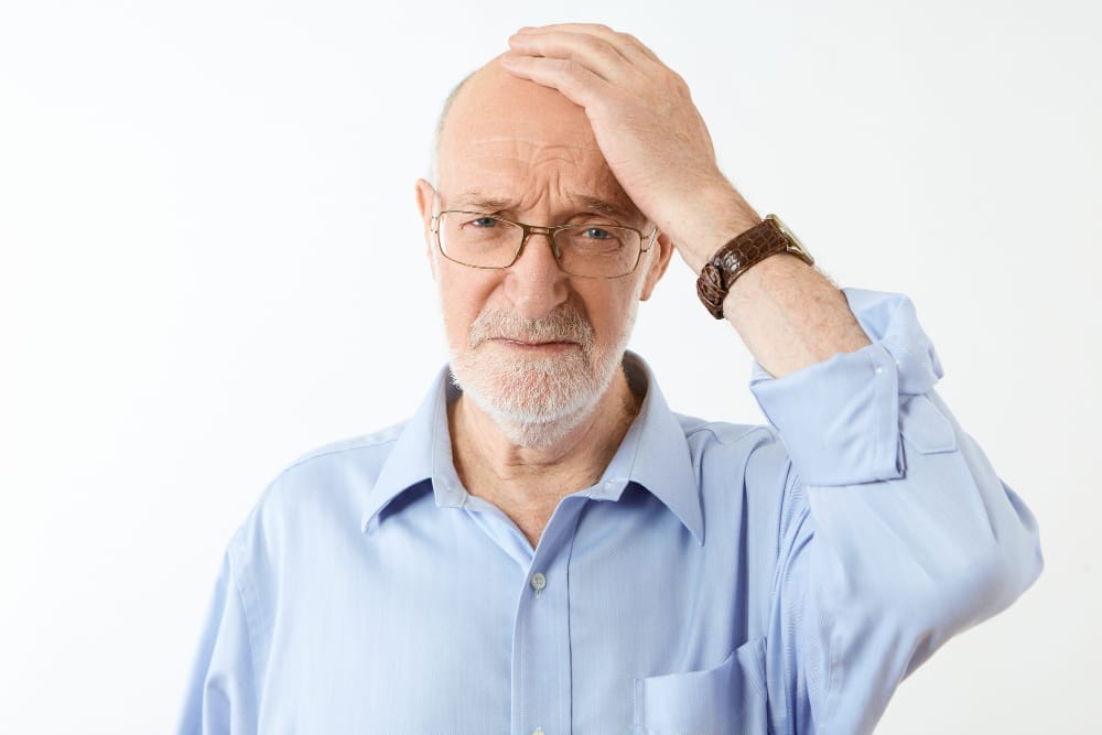 elderly man with a migraine | memory loss