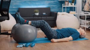 elderly man on a stability ball