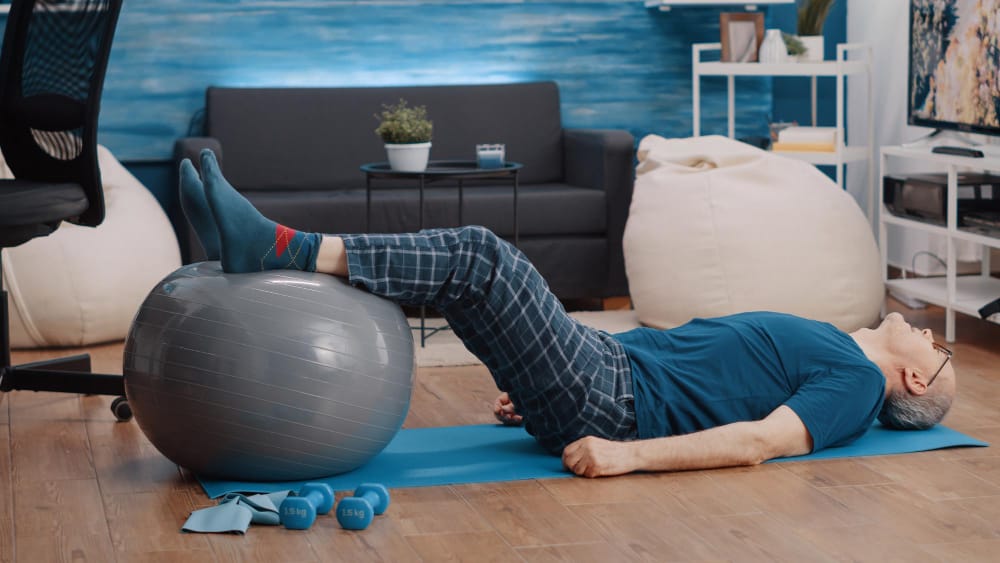 elderly man on a stability ball