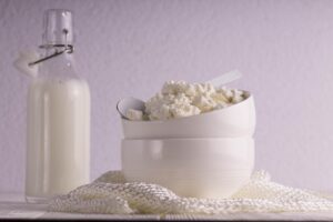 a jar of fresh milk and a bowl of cottage cheese